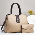 Detalle del conjunto de bolso en cuero sintético caqui con diseño bicolor y cierre de giro - Caqui