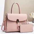 Close-up of pink litchi grain leather tote bag with elegant gold twist lock and accessories - 28/11/22 / Pink