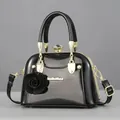 Glossy black patent leather shell handbag with gold hardware and rose charm - Glossy Black