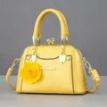 Mini shell-shaped handbag in bright yellow patent leather with floral charm - Glossy Yellow