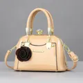 Mini shell-shaped beige patent leather crossbody bag with brown rose charm and gold hardware - Glossy Light Yellow