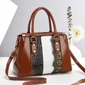 Fashionable brown glossy patchwork handbag for women with animal textures and shoulder strap - Earthy Yellow