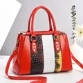 Red glossy patent leather handbag with luxury snake skin patchwork and gold hardware - Red