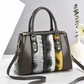 Gray patent leather handbag with snakeskin pattern and adjustable shoulder strap - Gray