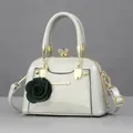 Creamy white shell mini handbag with golden metal handle and green rose charm - Glossy Cyan
