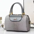 Grey crocodile embossed leather bucket bag with golden kangaroo logo and top handle - Gray