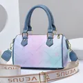 Boston bag with pastel gradient design and wide logo strap on a geometric background - Blue