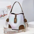 Pink and blue gradient bucket bag featuring floral prints and wide branded shoulder strap - Brown
