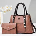 Close-up of vintage brown tote bag set with textured leather and adjustable shoulder strap - Pink