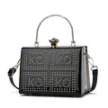 Detail of black patent leather handbag featuring gold rivet logo and crystal clasp - One Size / Black