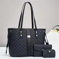 Close-up of a three-piece black tote bag set with textured print and gold hardware - Black