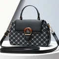 Elegant black handbag with white clover print and gold clasp for women, single handle style - Black