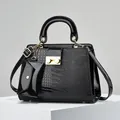 Fashionable black lizard pattern handbag set with glossy finish and gold hardware accents - Black