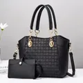 Detail of black tote bag set with geometric embossed texture and golden metal hardware - 28x12x25cm / Black