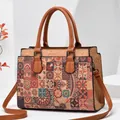 Front view of a vintage multi-color mandala pattern handbag with cork texture and brown handles - Style 4