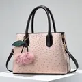 Pink ostrich pattern tote bag with brown handles and a cherry plush charm decoration - Pink