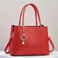 Elegant red pebbled leather tote bag with gold hardware and smiley charm for women - Red