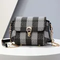 Women's black and white checkered crossbody bag with gold chain and metal buckle - Black