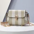 Chic beige and white striped crossbody bag with gold chain strap on display - Khaki