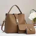 Detailed macro view of dark brown litchi pattern leather handbags with gold hardware - Dark Khaki