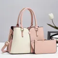 Detail of pink and beige patchwork handbag set with litchi grain and gold hardware - Pink