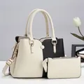 Detail view of contrast color handbag set with matching pouch and gold-tone hardware - Off White