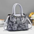 Detail of floral jacquard fabric on a stylish tote bag with adjustable leather straps - Sky Blue