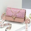 Pink sequin crossbody bag with gold heart lock and floral embroidered wide strap - Pink