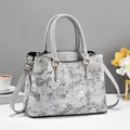 Chic grey handbag with white floral embroidery and gold hardware for women - Gray