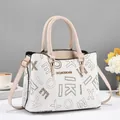 Detailed macro view of white pebble leather texture and golden brand logo engraving - White With Gold Letters