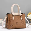 Detail of lychee pattern leather tote bag with elegant golden hardware and lettering - Khaki/Earth Yellow