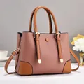Detail of lychee pattern leather and gold metal hardware on pink tote bag - Pink