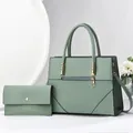 Detail view of sage green faux leather handbag set with geometric quilting and gold hardware - Green