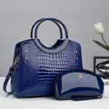 Detailed close-up of dark blue crocodile pattern handbag and patent leather pouch set - Shoulder Bag Set / Blue