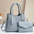 Light blue embossed tote bag set with matching pouch and adjustable shoulder strap - Blue