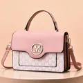 Detail of pink and beige crossbody bag with gold M-logo and monogram patterns - Pink