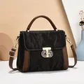 Chic black pleated shoulder bag with brown leather contrast and gold T-shaped clasp - Black