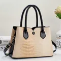 Chic beige crocodile embossed handbag with black patent leather accents and gold hardware - Off White