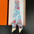 Detailed view of summer twilly silk scarf with colorful motifs in an orange gift box - Blue-Pink Series Cartoon (C312-5)
