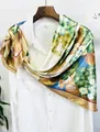 Detailed texture of the hydrangea floral silk scarf draped on a wooden hanger - One Size / Khaki
