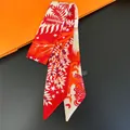 Close-up of tropical jungle pattern skinny scarf on classic orange gift box packaging - Red White Contrast (C267-4)