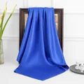 Detail of dark blue silk satin square scarf draped elegantly on a wooden frame - Blue