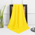 Macro detail of vibrant yellow satin square scarf draped over a wooden vintage frame - Yellow