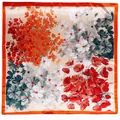 Close-up of floral print silk scarf with orange borders and soft botanical pattern - Orange