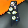 Detailed shot of a black twilly silk scarf featuring heart and horse motifs with orange gift box - Black Horse Heart Style (C239-1)