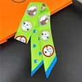 Neon green twilly silk scarf with horse head patterns next to an orange gift box - Fluorescent Green Horse Heart Style (C239-3)
