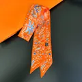 Close-up of vibrant orange twilly silk scarf with abstract pattern and satin texture - Bright Orange Print (C248-3)