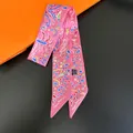 Close-up of pink twilly scarf with abstract patterns on an orange gift box - Light Pink Print (C248-4)