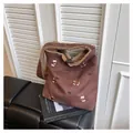 Detail of suede tote bag featuring puppy embroidery and cozy faux shearling lining - One Size / Coffee