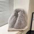 Plush faux fur bucket bag in grey with thick fluffy texture for a minimalist winter style - With Pendant / Gray